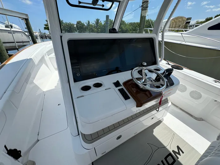  Yacht Photos Pics 2025 Phenom 37 boat cockpit with modern steering and navigation system.