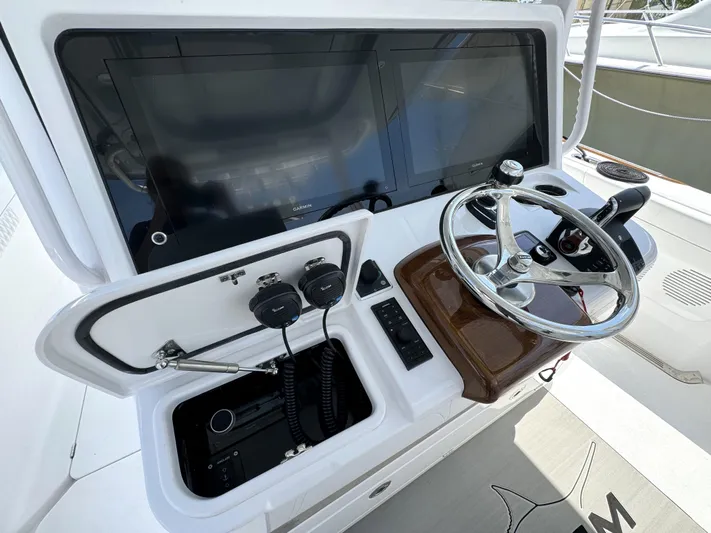  Yacht Photos Pics Phenom 37 boat dashboard with steering wheel and electronic controls, 2025 model.