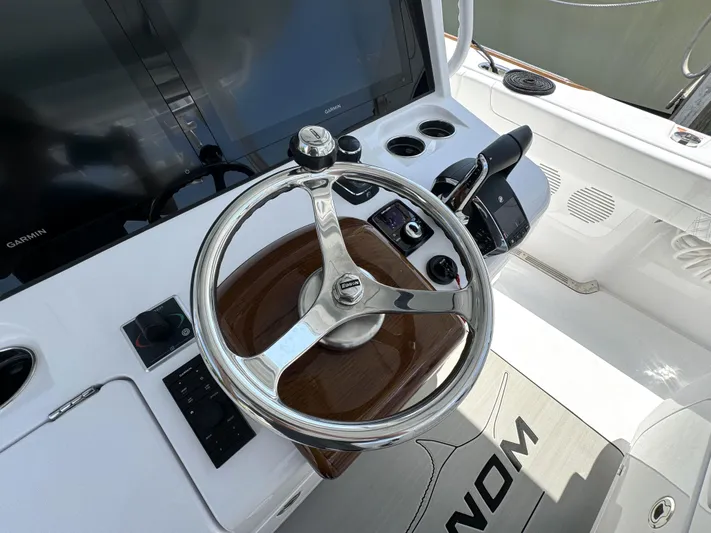  Yacht Photos Pics Steering wheel and controls of 2025 Phenom 37 boat cockpit.