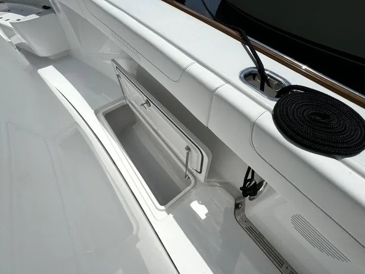  Yacht Photos Pics 2025 Phenom 37 boat deck with storage compartment and coiled rope.