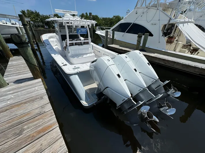  Yacht Photos Pics 2025 Phenom 37 boat docked with triple outboard engines.