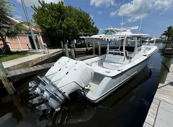  Yacht Photos Pics 2025 Phenom 37 boat docked, featuring powerful outboard engines and sleek design.