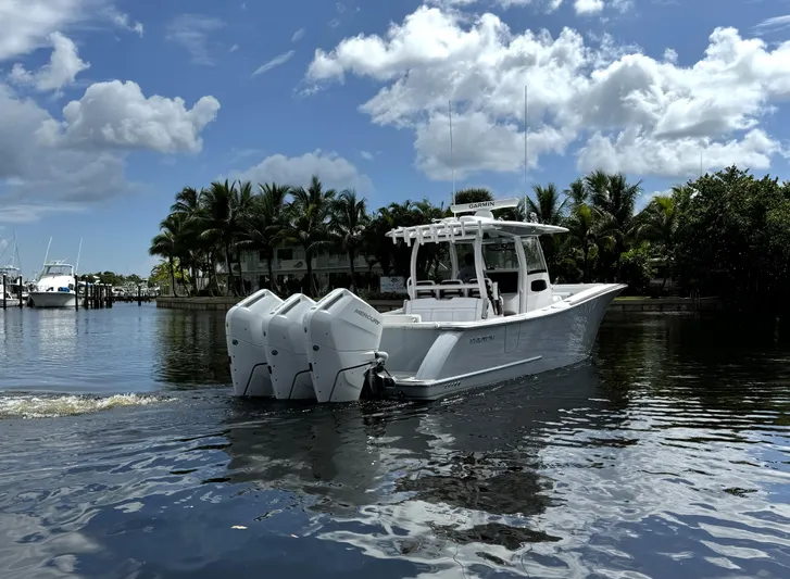  Yacht Photos Pics 2025 Phenom 37 boat with triple engines cruising on a sunny day.