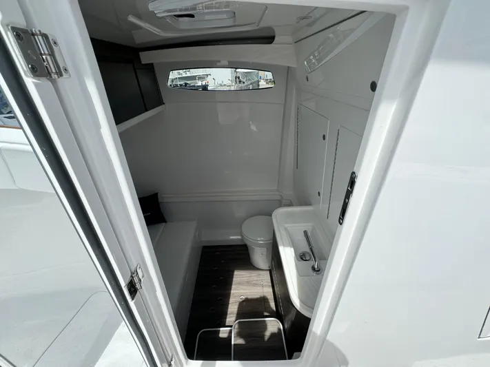  Yacht Photos Pics Compact bathroom interior of 2025 Phenom 37 boat, featuring toilet and sink.