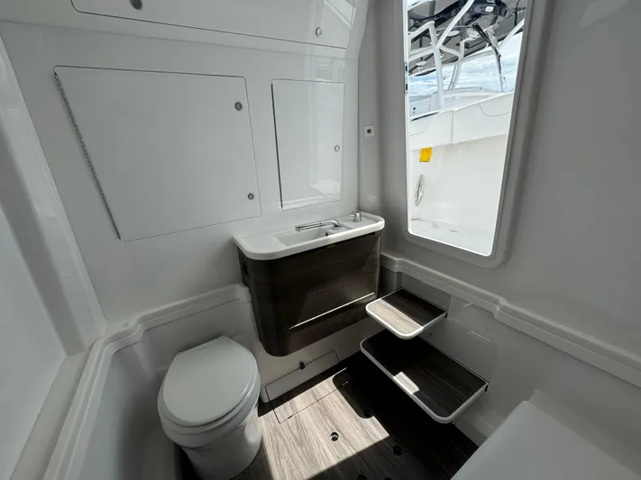  Yacht Photos Pics Modern bathroom interior on a 2025 Phenom 37 boat, featuring sleek design and compact fixtures.