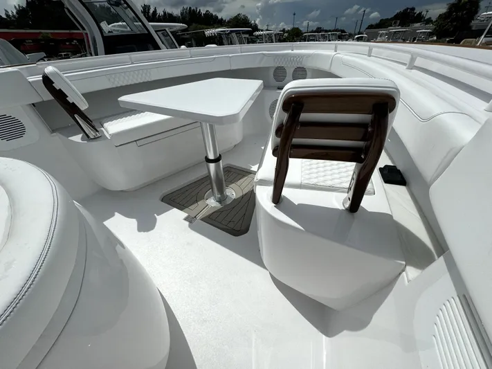  Yacht Photos Pics Luxurious seating area on a 2025 Phenom 37 boat with table and chairs.