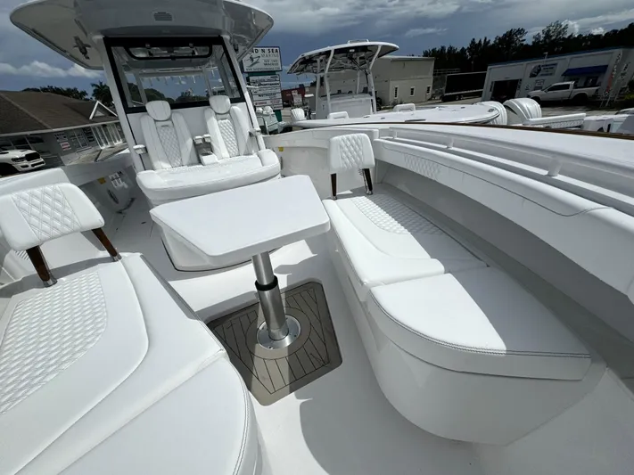  Yacht Photos Pics Luxurious 2025 Phenom 37 boat interior with white seating and table.