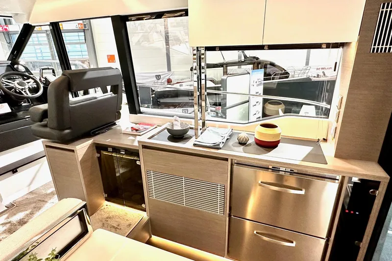  Yacht Photos Pics Modern interior of 2026 Jeanneau Merry Fisher 1295 Fly yacht, featuring sleek kitchen design.