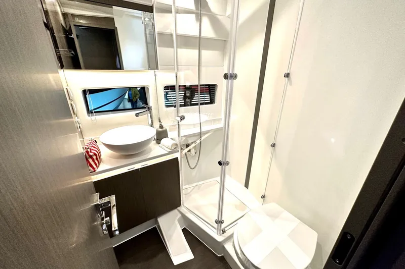  Yacht Photos Pics Modern bathroom in 2026 Jeanneau Merry Fisher 1295 Fly yacht, featuring sleek design and amenities.