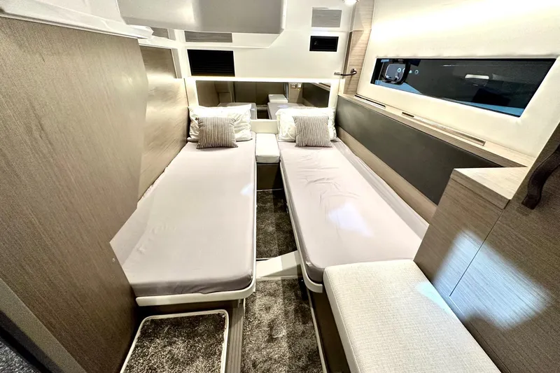  Yacht Photos Pics Luxurious cabin interior of 2026 Jeanneau Merry Fisher 1295 Fly with twin beds.