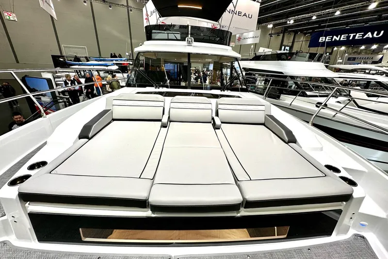  Yacht Photos Pics 2026 Jeanneau Merry Fisher 1295 Fly yacht with spacious sunbathing area at a boat show.