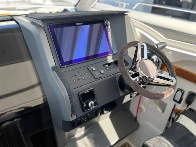 Ala #210 In Stock Yacht Photos Pics 2023 Nimbus W9 boat dashboard with steering wheel and touchscreen display.