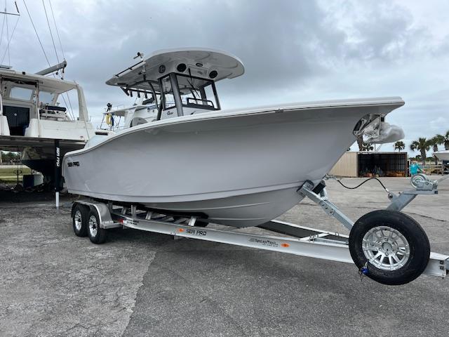 2025 Sea Pro 262 Sport boat on trailer, parked outdoors.