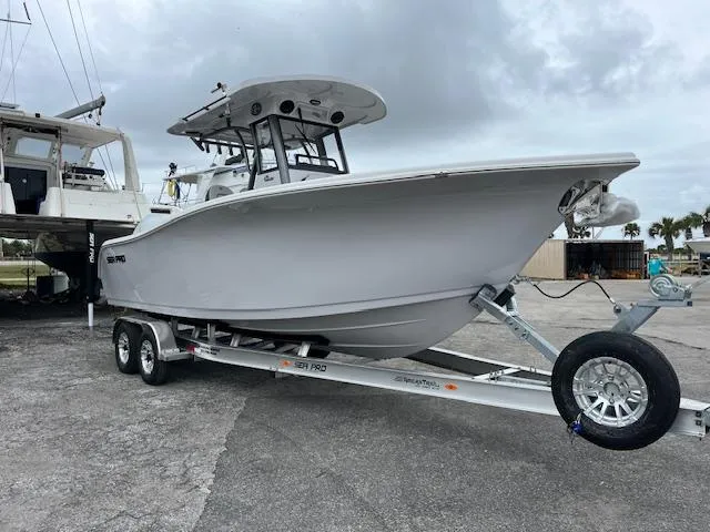 2025 Sea Pro 262 Sport boat on trailer, parked outdoors.