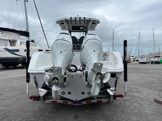 2025 Sea Pro 262 Sport boat with dual outboard engines, docked in a marina.