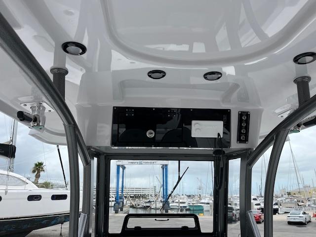 2025 Sea Pro 262 Sport boat interior with overhead console and marina view.