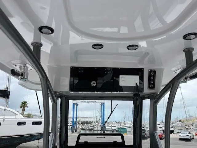2025 Sea Pro 262 Sport boat interior with overhead console and marina view.