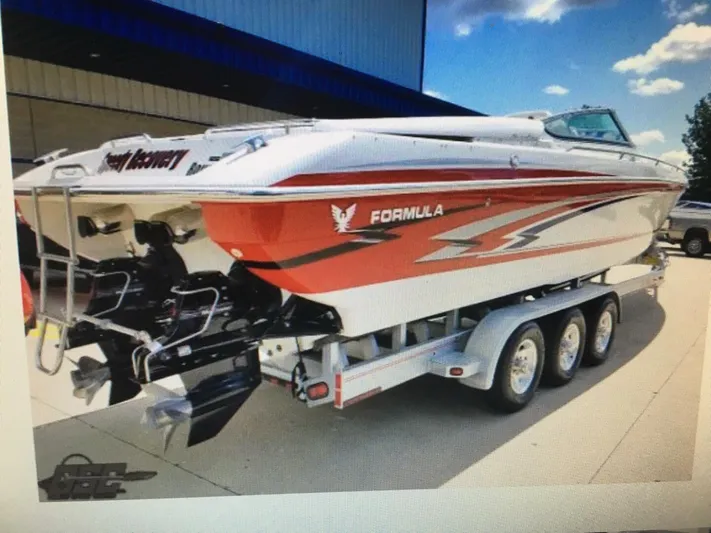  Yacht Photos Pics 2005 Formula 353 FASTech speedboat on trailer, red and white design, parked outdoors.