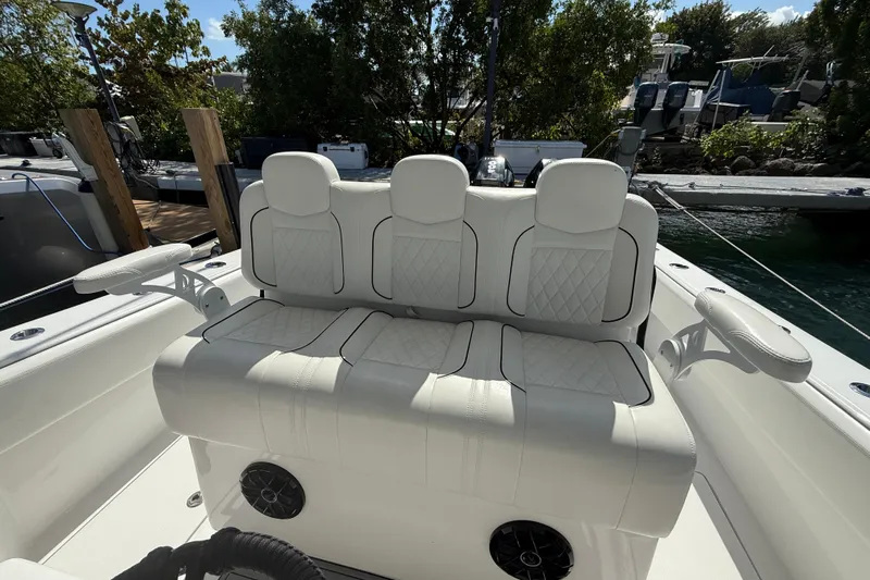  Yacht Photos Pics 2024 SeaHunter 35 Tournament boat with luxurious white seating and armrests, docked near water.