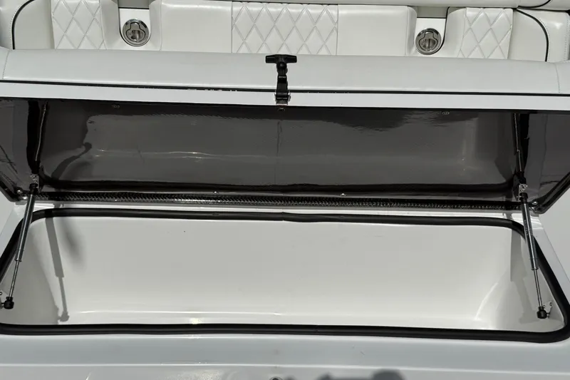  Yacht Photos Pics Open storage compartment on 2024 SeaHunter 35 Tournament boat with white cushioned seating.