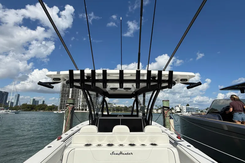  Yacht Photos Pics 2024 SeaHunter 35 Tournament boat docked, clear sky, city skyline in background.