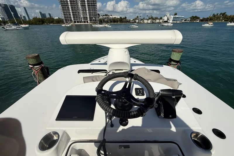  Yacht Photos Pics 2024 SeaHunter 35 Tournament boat helm with steering wheel, controls, and water view.