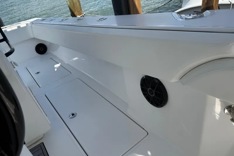  Yacht Photos Pics 2024 SeaHunter 35 Tournament boat interior with sleek white seating and storage compartments.