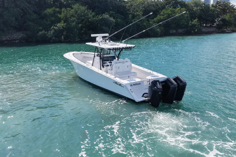  Yacht Photos Pics 2024 SeaHunter 35 Tournament boat on clear blue water, featuring dual outboard engines.