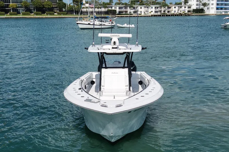  Yacht Photos Pics 2024 SeaHunter 35 Tournament boat on calm water, with coastal buildings in the background.