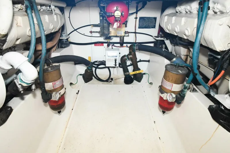 Vikingos Yacht Photos Pics Engine room of a 2001 Cabo 35 Flybridge boat with dual engines and fuel filters.