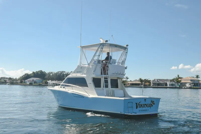 Vikingos Yacht Photos Pics 2001 Cabo 35 Flybridge boat cruising on a sunny day.