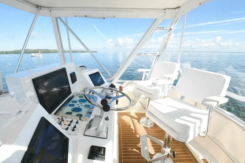 Vikingos Yacht Photos Pics Flybridge helm of 2001 Cabo 35 Flybridge yacht with ocean view.