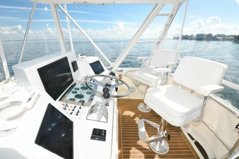 Vikingos Yacht Photos Pics 2001 Cabo 35 Flybridge helm with dual captain chairs and ocean view.
