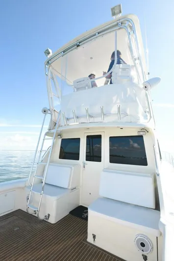 Vikingos Yacht Photos Pics 2001 Cabo 35 Flybridge boat with upper deck and seating area.