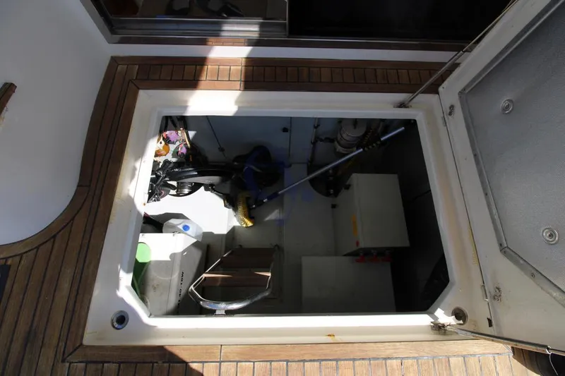 C Yacht Photos Pics 1999 Azimut 42 yacht storage compartment with cleaning supplies and equipment.