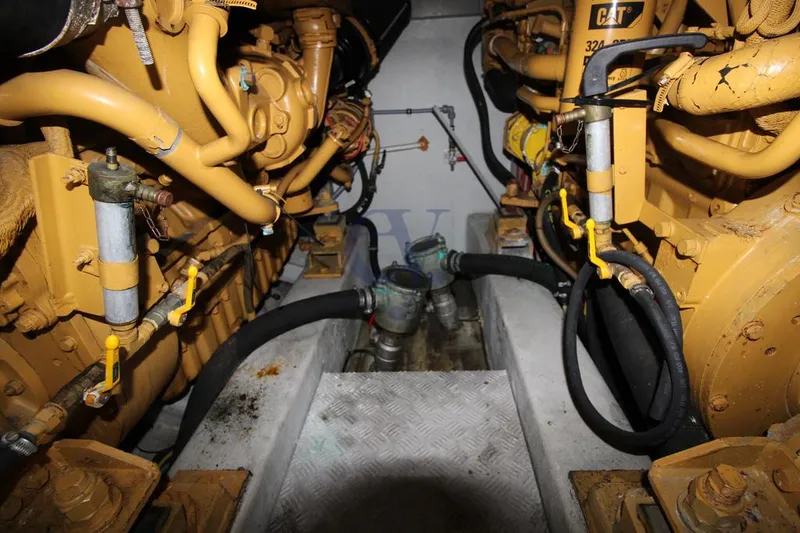 C Yacht Photos Pics Engine room of a 1999 Azimut 42 yacht, featuring Caterpillar engines and mechanical components.