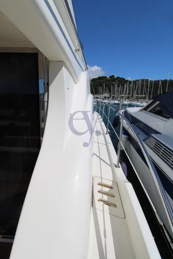 C Yacht Photos Pics 1999 Azimut 42 yacht deck with marina view, clear sky, and adjacent boats.