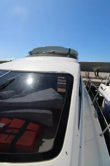 C Yacht Photos Pics 1999 Azimut 42 yacht with sleek design, docked under clear blue sky.