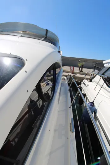 C Yacht Photos Pics 1999 Azimut 42 yacht docked, showcasing sleek design and polished exterior under clear blue sky.