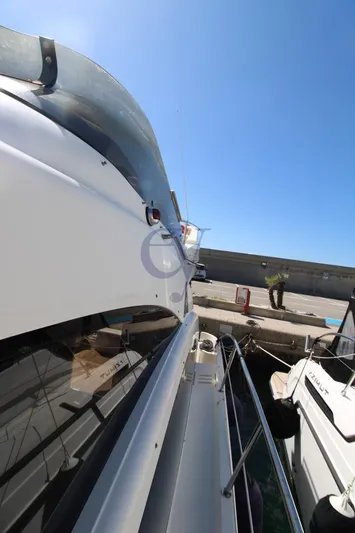 C Yacht Photos Pics 1999 Azimut 42 yacht docked at marina under clear blue sky.