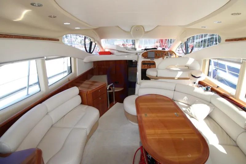C Yacht Photos Pics Luxurious interior of a 1999 Azimut 42 yacht with elegant seating and wooden table.