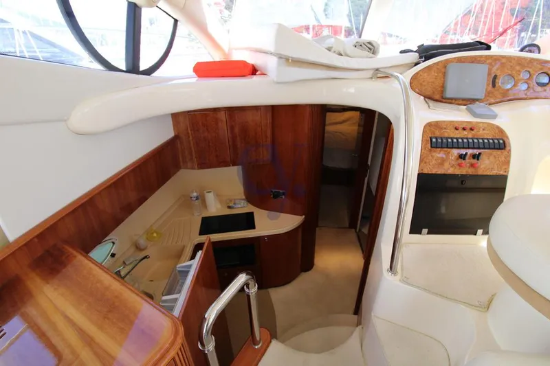C Yacht Photos Pics Interior of 1999 Azimut 42 yacht, featuring a compact kitchen and control panel.