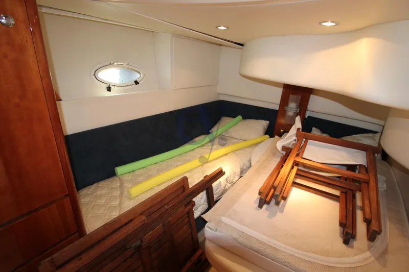 C Yacht Photos Pics 1999 Azimut 42 yacht cabin with wooden furniture and pool noodles.