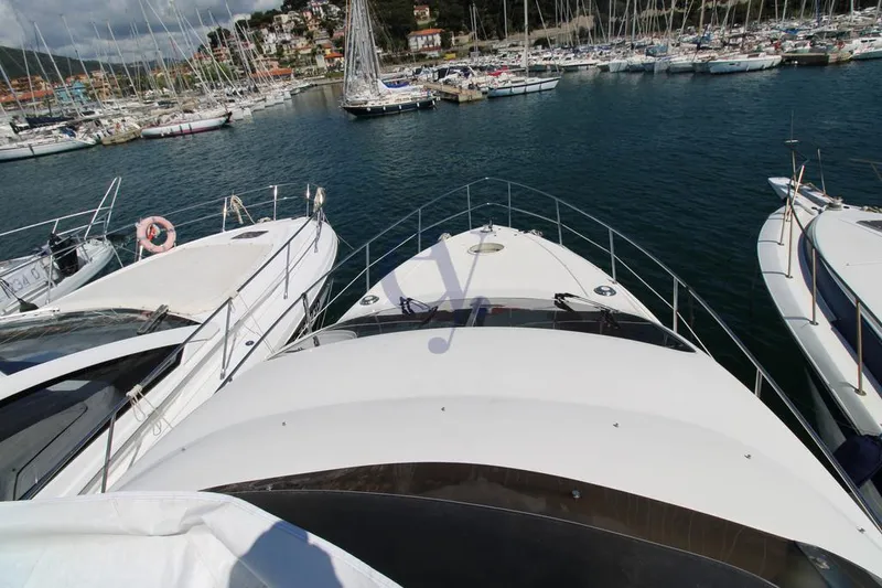 C Yacht Photos Pics Azimut 42 yacht from 1999 docked in a marina with surrounding boats.