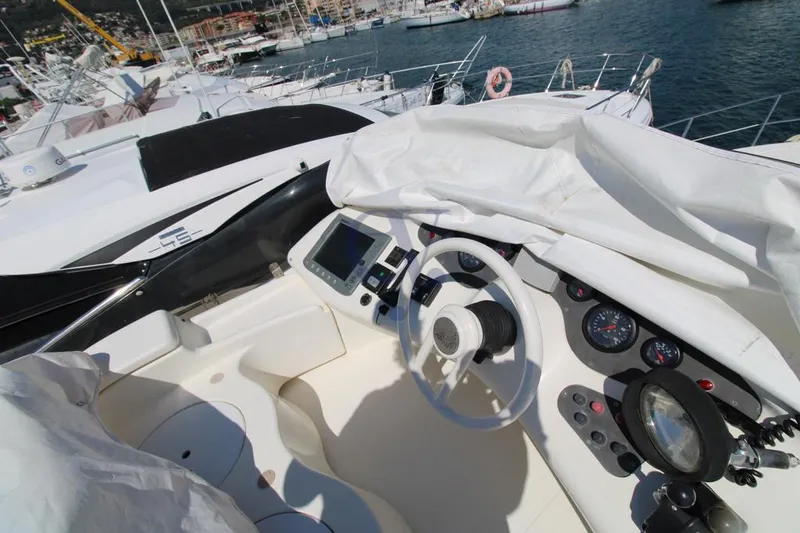 C Yacht Photos Pics Cockpit of a 1999 Azimut 42 yacht with steering wheel and navigation instruments.