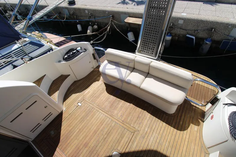 C Yacht Photos Pics 1999 Azimut 42 yacht deck with seating and wooden flooring.