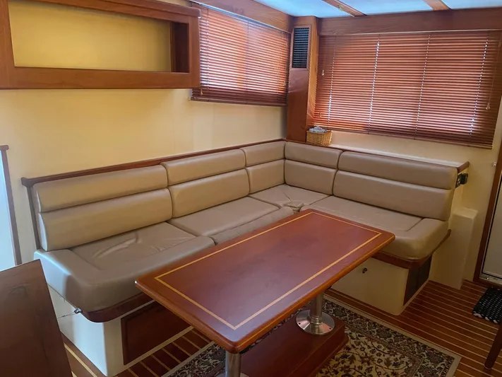 Endurance Yacht Photos Pics 2006 Duffy Pilothouse Fast Trawler interior with beige seating and wooden table.