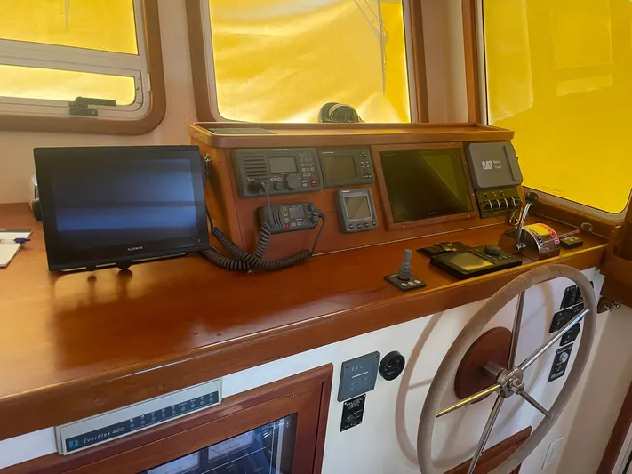 Endurance Yacht Photos Pics Pilothouse interior of 2006 Duffy Fast Trawler with navigation equipment and steering wheel.