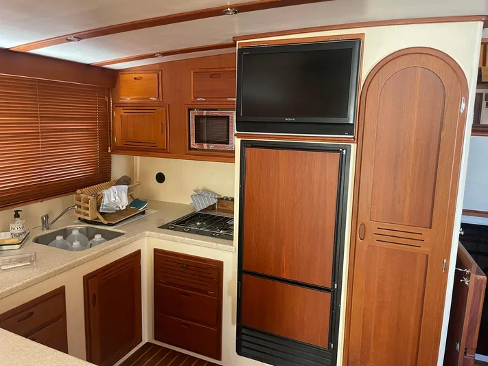 Endurance Yacht Photos Pics 2006 Duffy Pilothouse Fast Trawler kitchen with wood cabinets, sink, and built-in appliances.