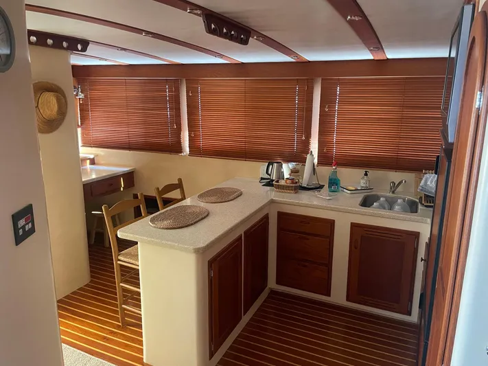Endurance Yacht Photos Pics 2006 Duffy Pilothouse Fast Trawler interior with wooden blinds, kitchenette, and seating area.